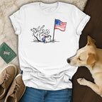 White t-shirt with a cartoon dog and "1776-2026" next to a flag.