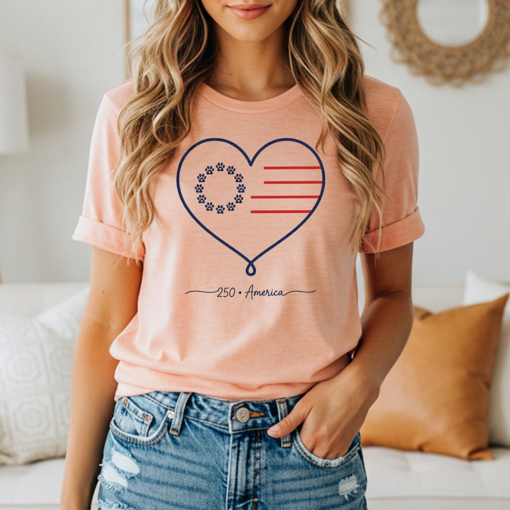 Peach t-shirt with a heart design featuring paw prints and an American flag.