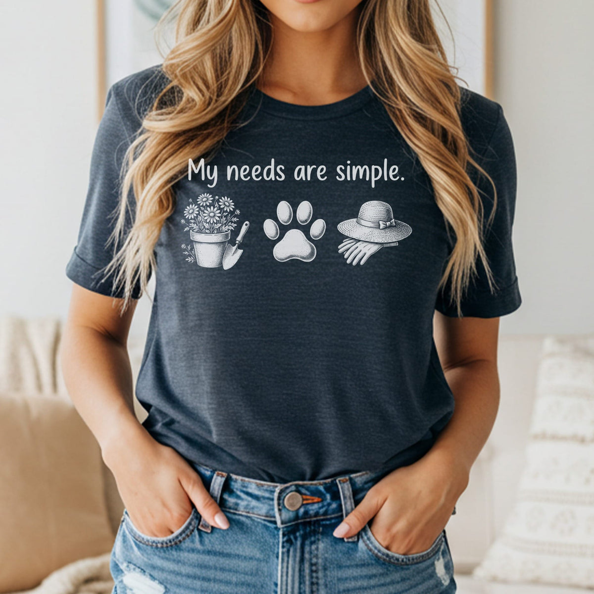 T-shirt with text "My needs are simple" and icons of gardening, paw print, and hat.