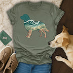 Green t-shirt with a dog silhouette filled with ocean and beach scenery.
