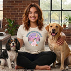 Woman with two dogs wearing a shirt with a Halloween dog graphic.