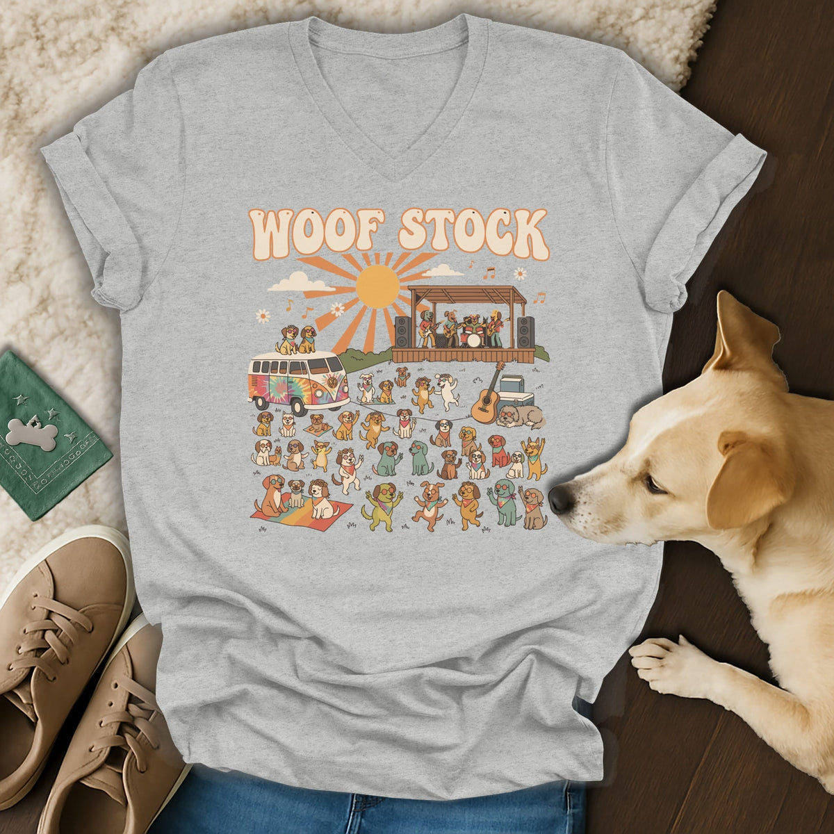 T-shirt graphic: "WOOF STOCK" text above a scene with a tie-dye van, band, and many dogs.