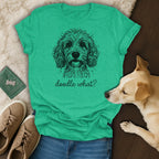 Green t-shirt with a sketch of a doodle dog and the text "doodle what?".