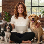 Woman wearing a "I'M KIND OF A BIG DEAL according to my dog" t-shirt with two dogs.