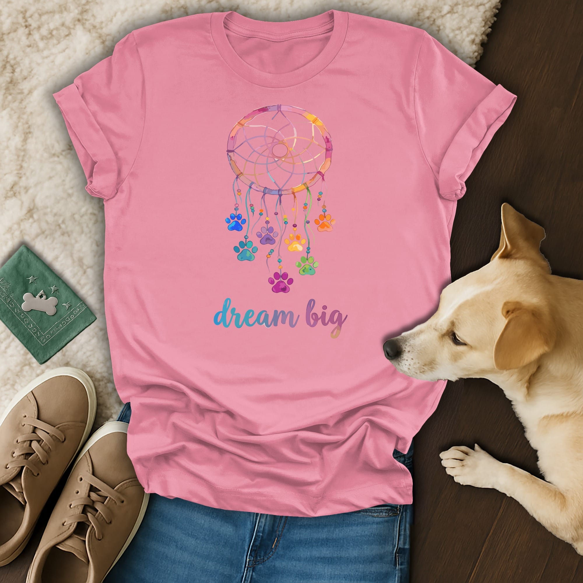 Pink t-shirt with colorful dreamcatcher and paw print design, "dream big" text.