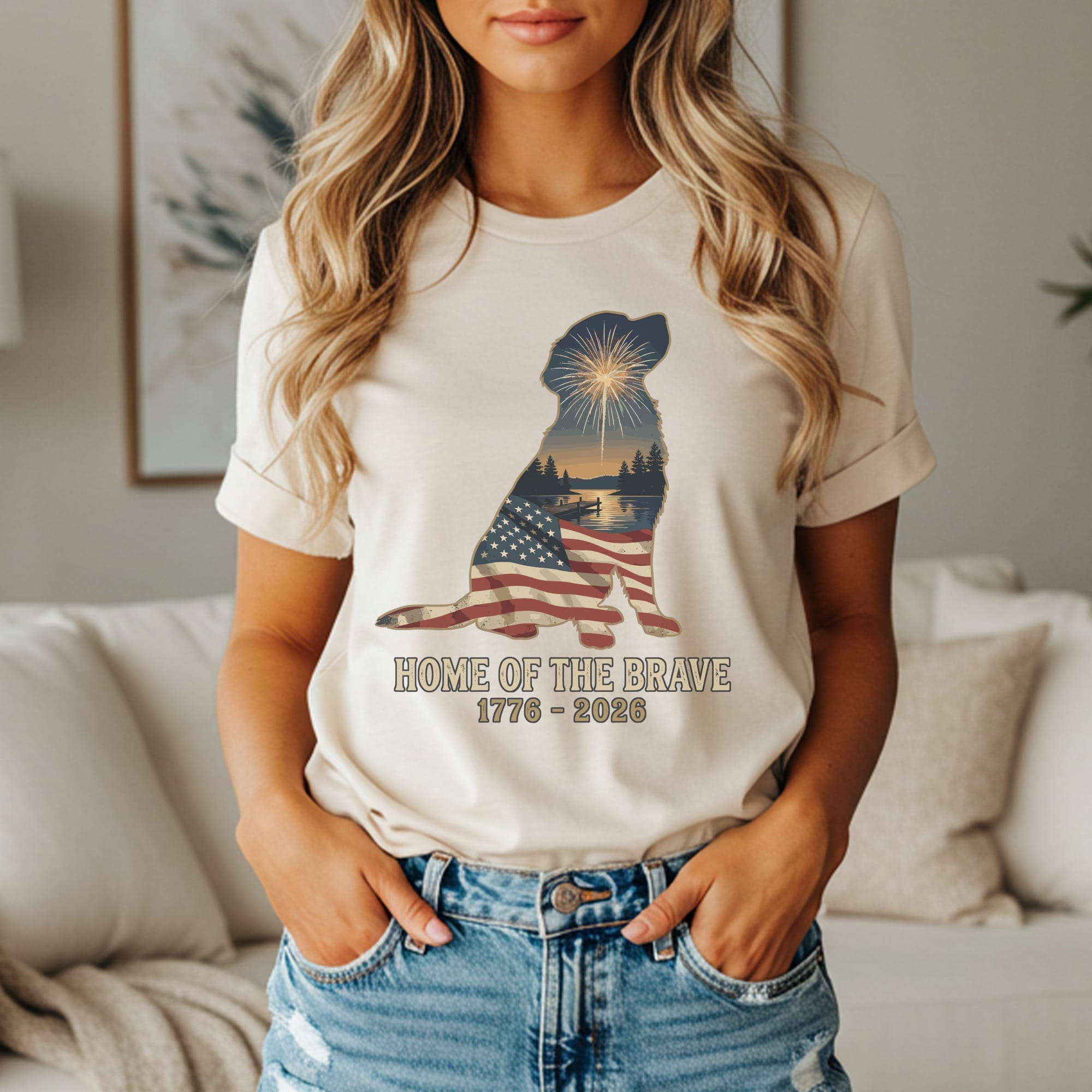 T-shirt featuring dog silhouette with American flag and fireworks, reading "HOME OF THE BRAVE 1776-2026."