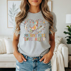 Graphic tee with a colorful dog and text that reads "FORGIVE FAST LOVE FASTER".