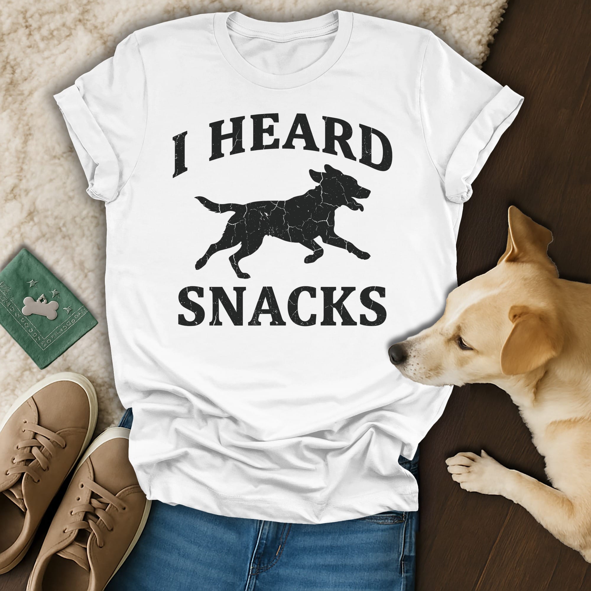 White t-shirt with black silhouette of a running dog and text "I HEARD SNACKS".