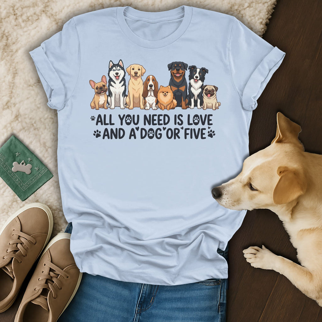 Light blue t-shirt with dogs and text "All you need is love and a dog".
