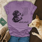 T-shirt with black and white dachshund blowing dandelion seeds, "Wiener Wishes" text.