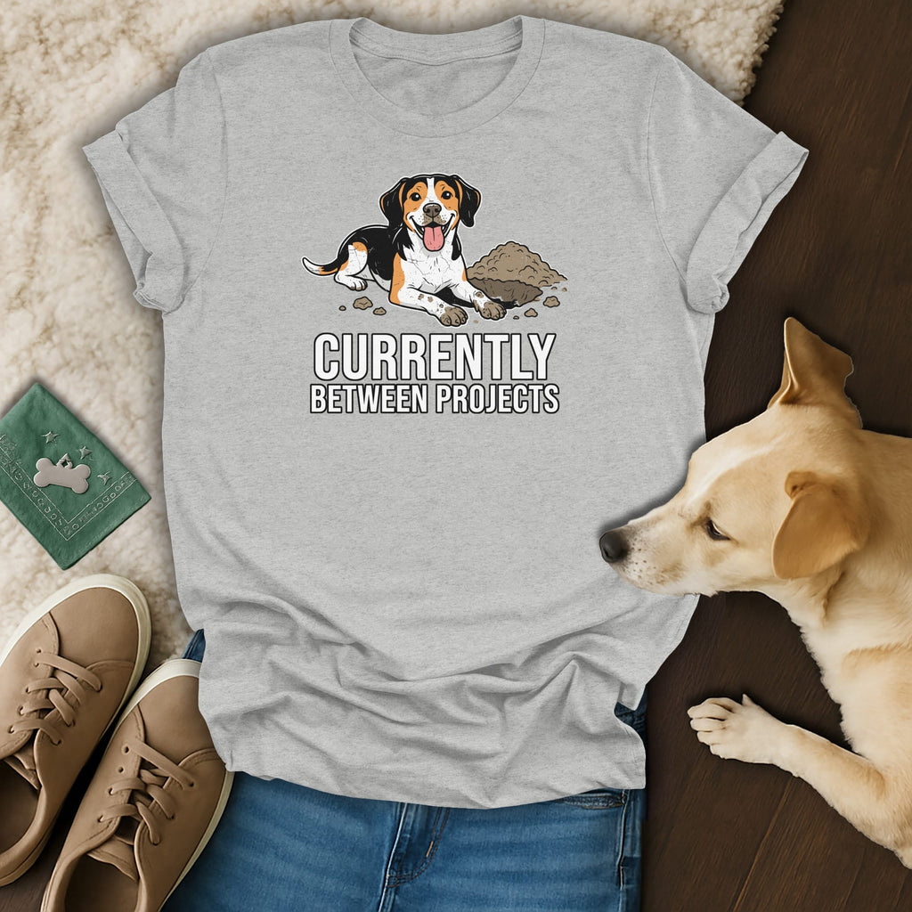 T-shirt with cartoon dog and text "Currently Between Projects".