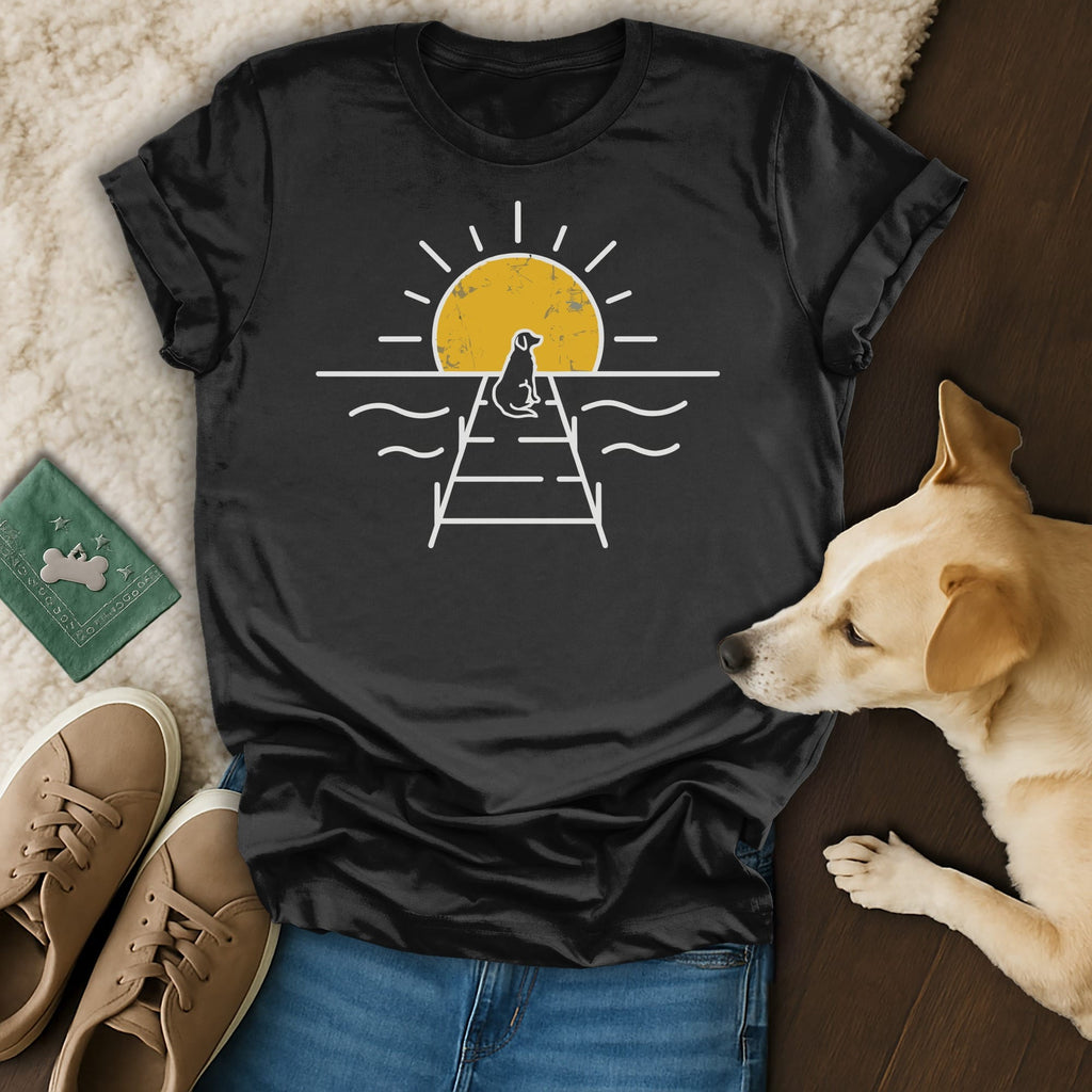 Black t-shirt with a dog on a pier at sunset graphic.