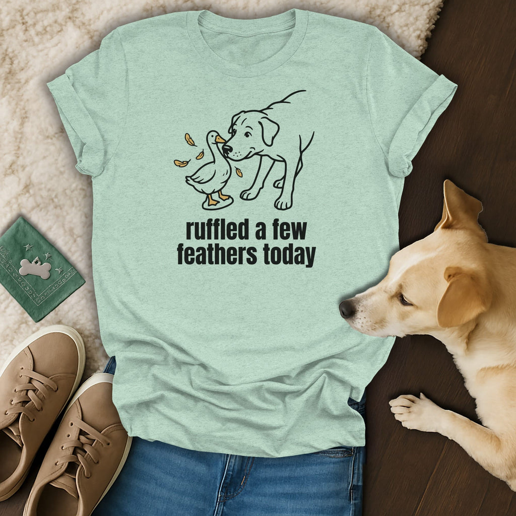 Light green t-shirt with dog and duck illustration, saying "ruffled a few feathers today".