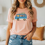 Peachy t-shirt with cartoon graphic of dogs in a van with hearts.