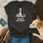 T-shirt with beagle sitting on scattered pillows with "MINOR INCIDENT" text.