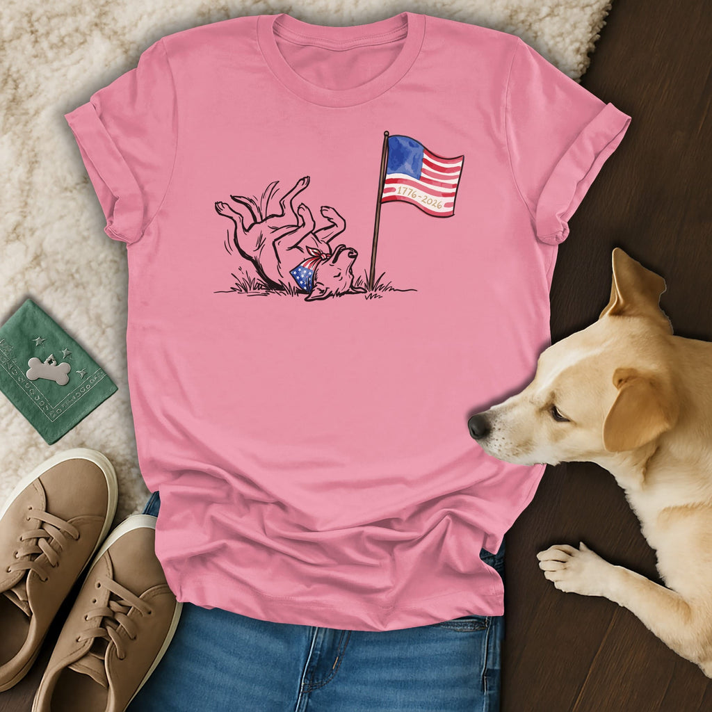 Pink t-shirt with playful dog and American flag graphic, "1776-2026".
