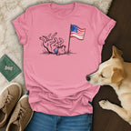 Pink t-shirt with playful dog and American flag graphic, "1776-2026".