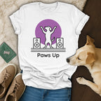 White t-shirt with "Paws Up" and dancing dog graphic on purple circle.
