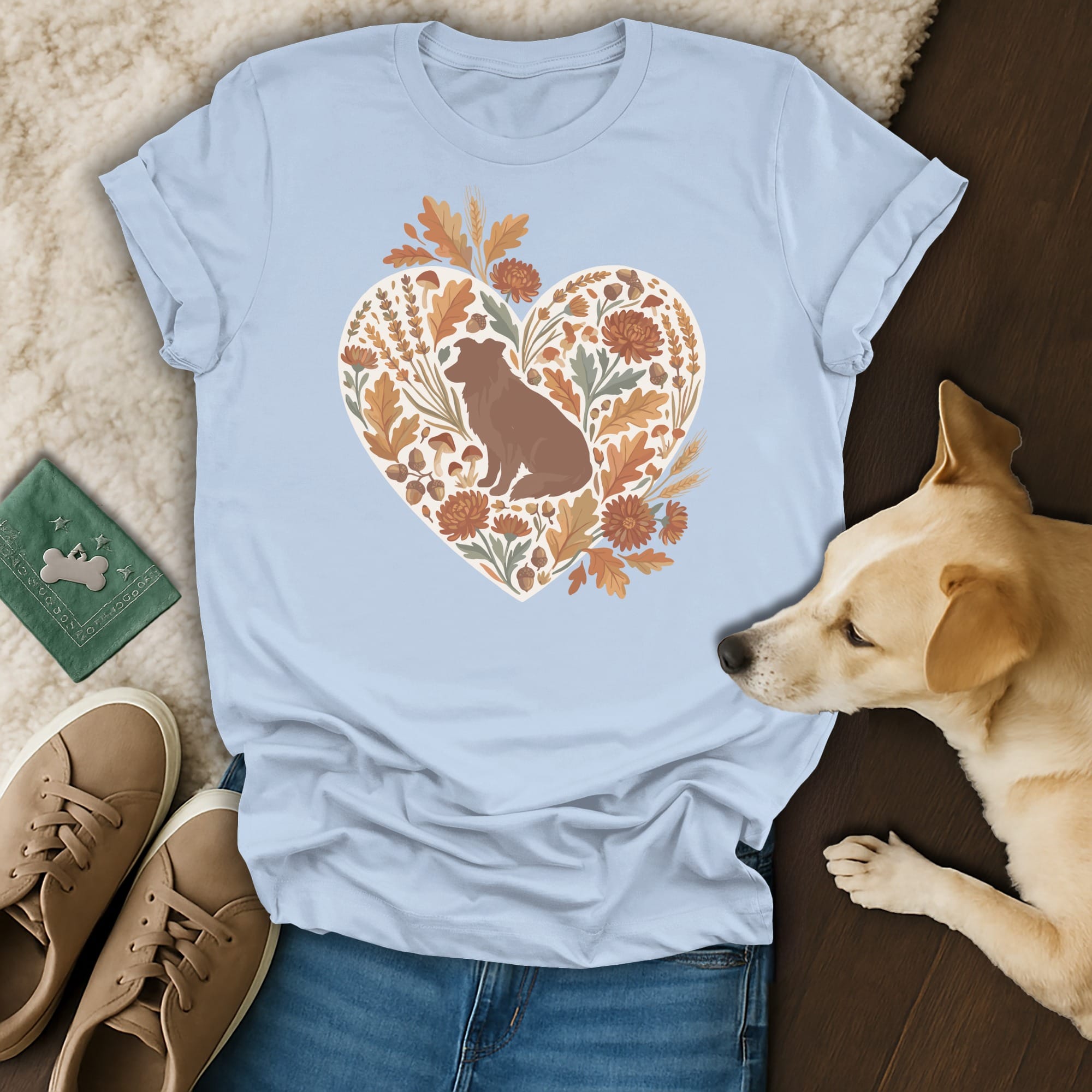 Light blue t-shirt with heart graphic of a seated dog and fall foliage.
