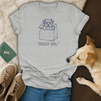Grey t-shirt with a graphic of a dog in a bag and the text "DOGGY BAG."
