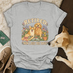 Heather grey v-neck t-shirt with a graphic of a corgi and golden retriever surrounded by flowers, reading Retired Now I Just Pet Dogs.