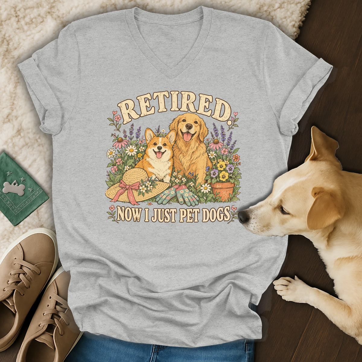 Heather grey v-neck t-shirt with a graphic of a corgi and golden retriever surrounded by flowers, reading Retired Now I Just Pet Dogs.
