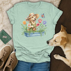 Golden retriever wearing a straw hat watering flowers with a butterfly.