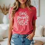 Coral t-shirt with white script text "Dog people get it" and paw prints.