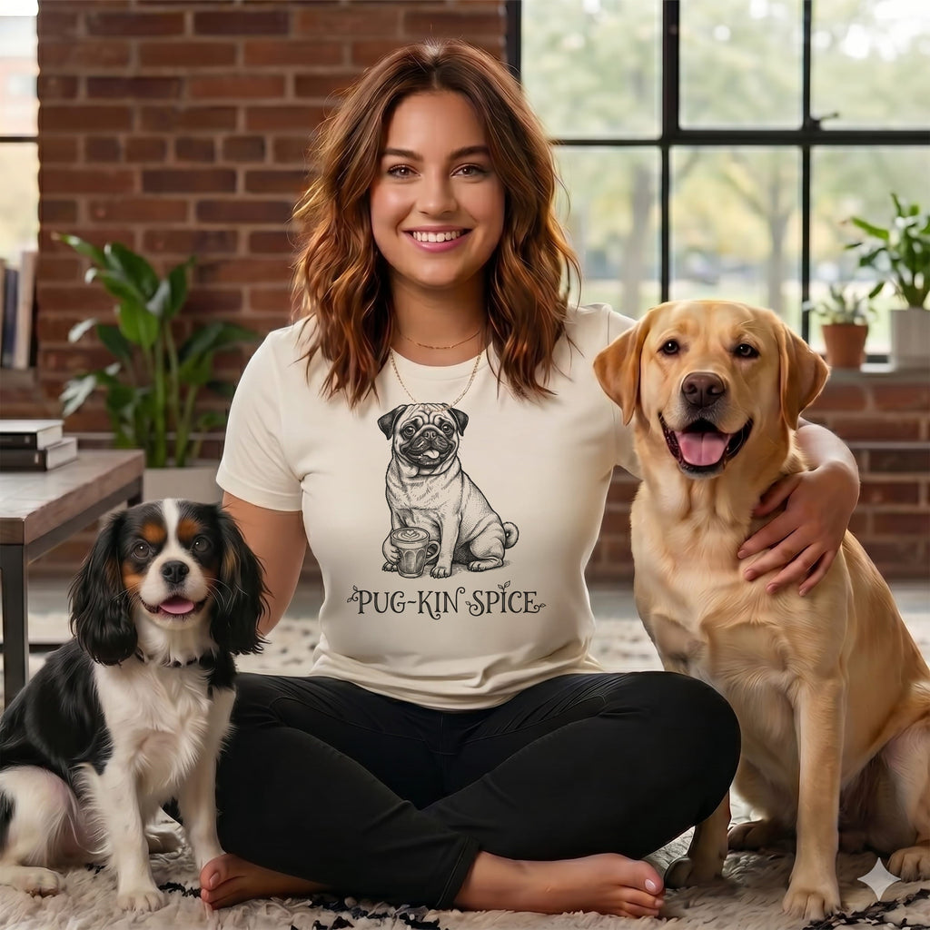 Woman with pug and labrador, wearing shirt with pug-kin spice text.