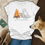 Labrador puppies and adult dog sitting by a campfire on a t-shirt.