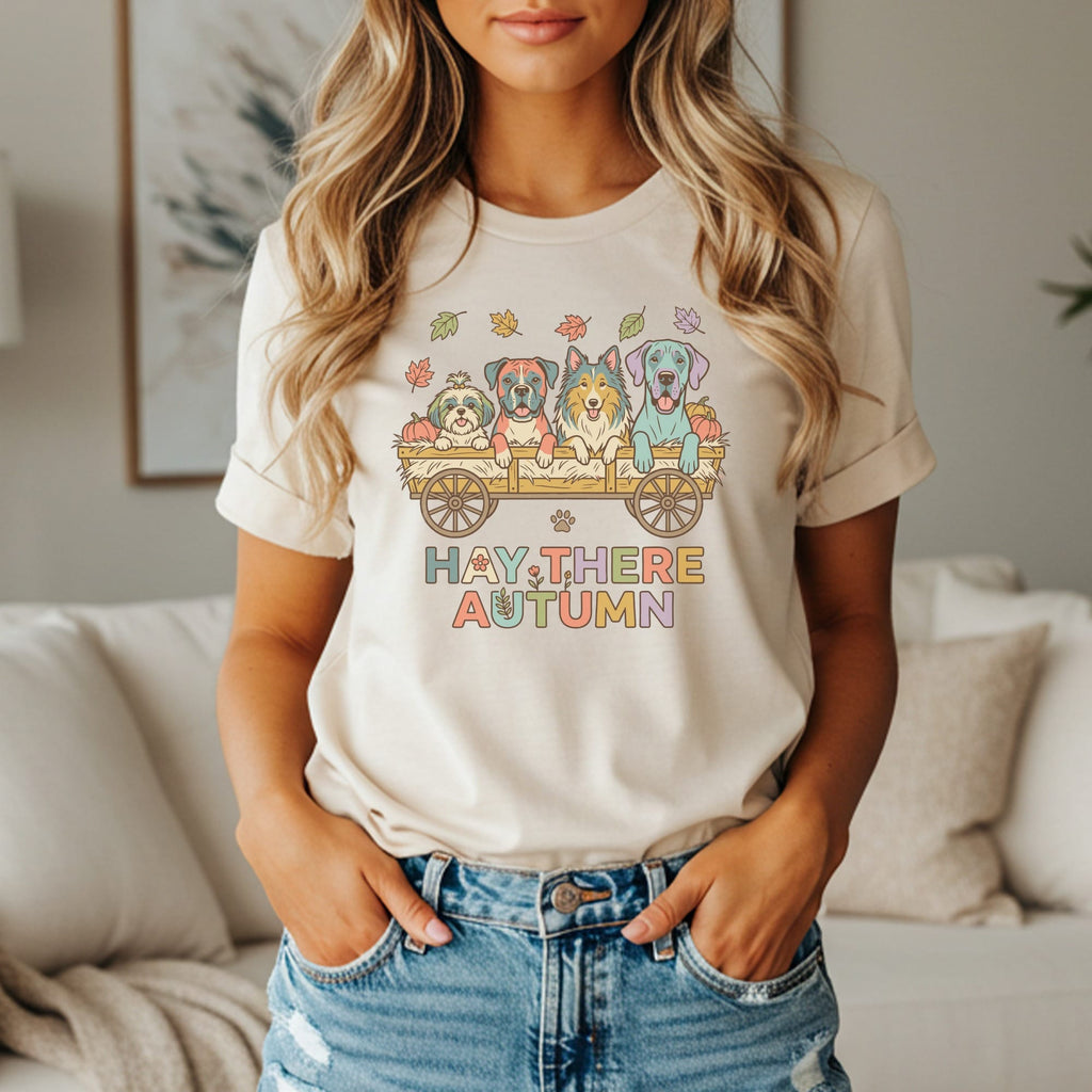 T-shirt graphic: four dogs in a hay cart with text "HAY THERE AUTUMN"