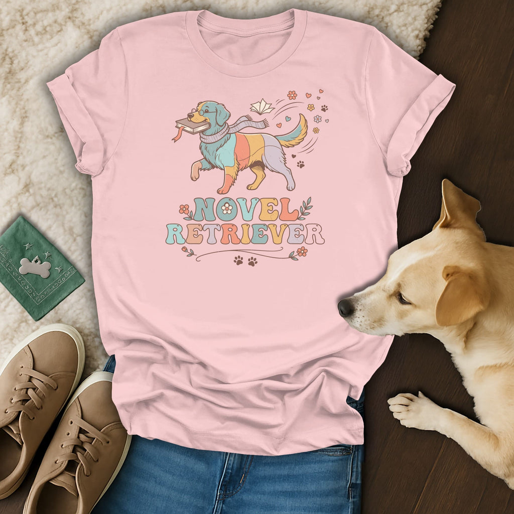 Pink t-shirt with colorful dog graphic holding a book and the text "Novel Retriever".