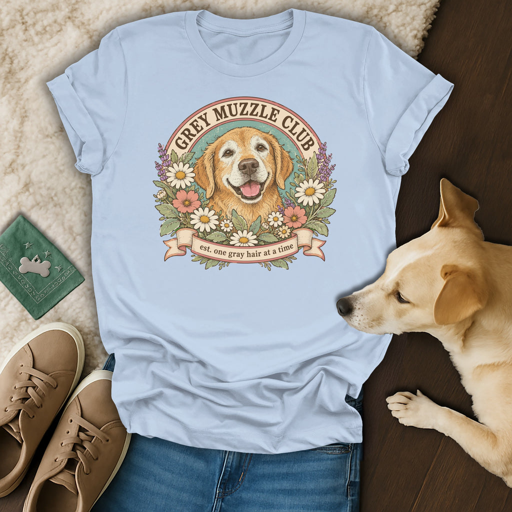 A light blue t-shirt printed with a golden retriever graphic and the text Grey Muzzle Club.