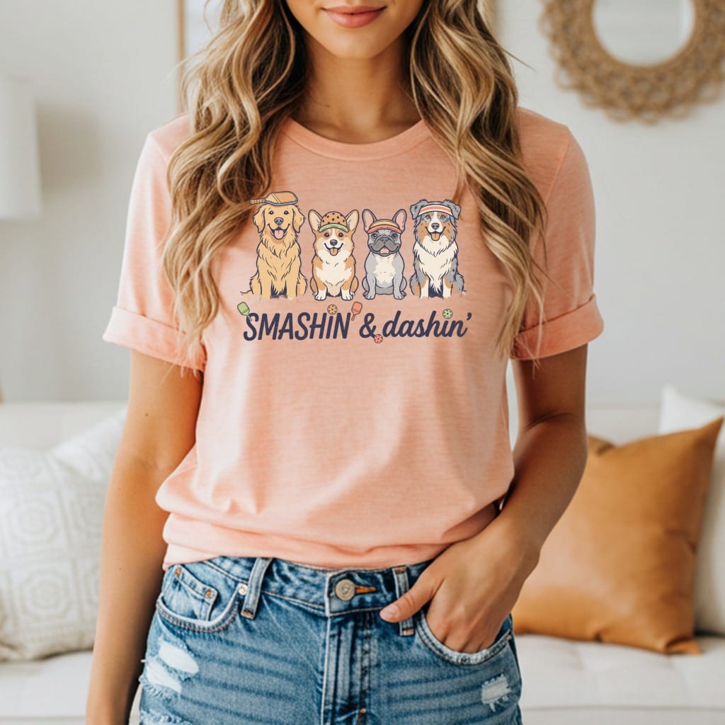 T-shirt with "SMASHIN' & dashin'" text and cartoon dogs playing pickleball.