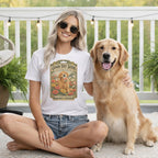 A smiling blonde woman in a white t-shirt sits beside a golden retriever on a porch.