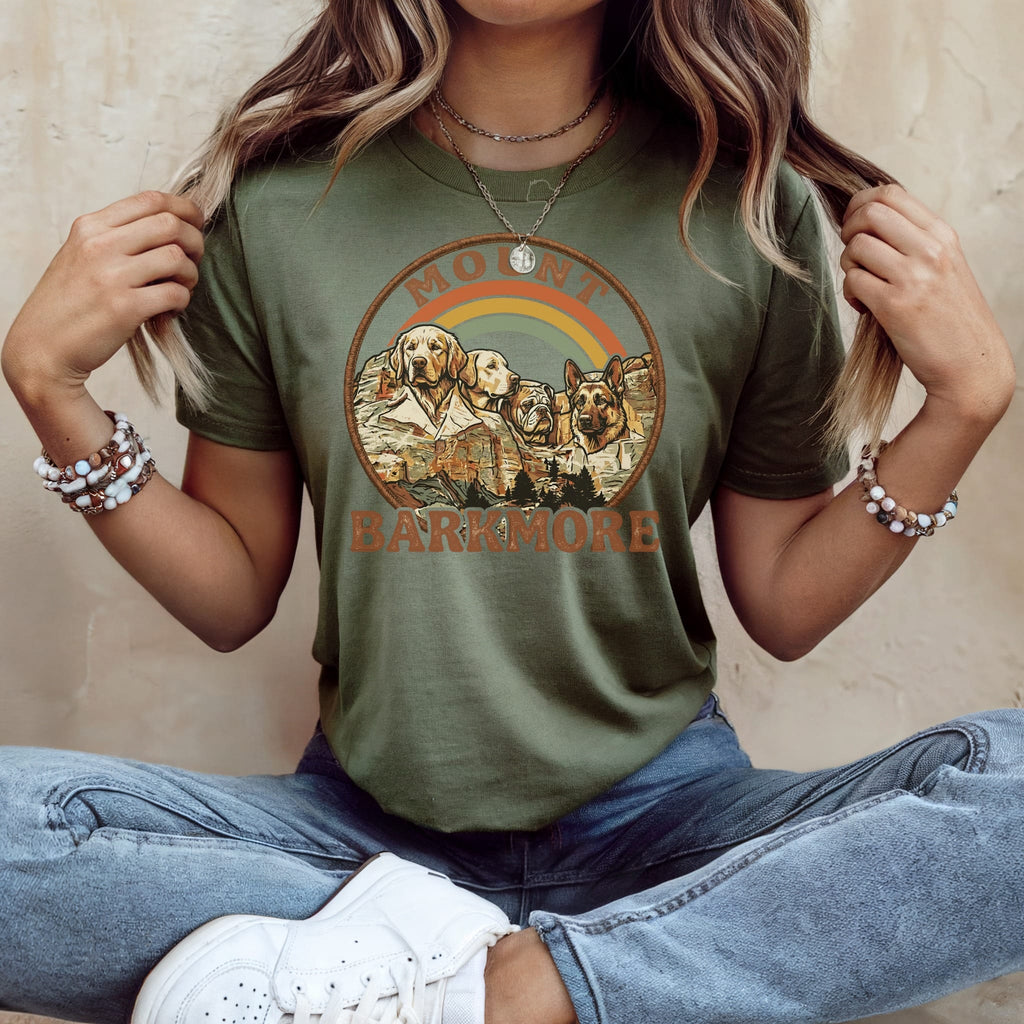 Green t-shirt with "Mount Barkmore" text and dog silhouettes against a mountain landscape.