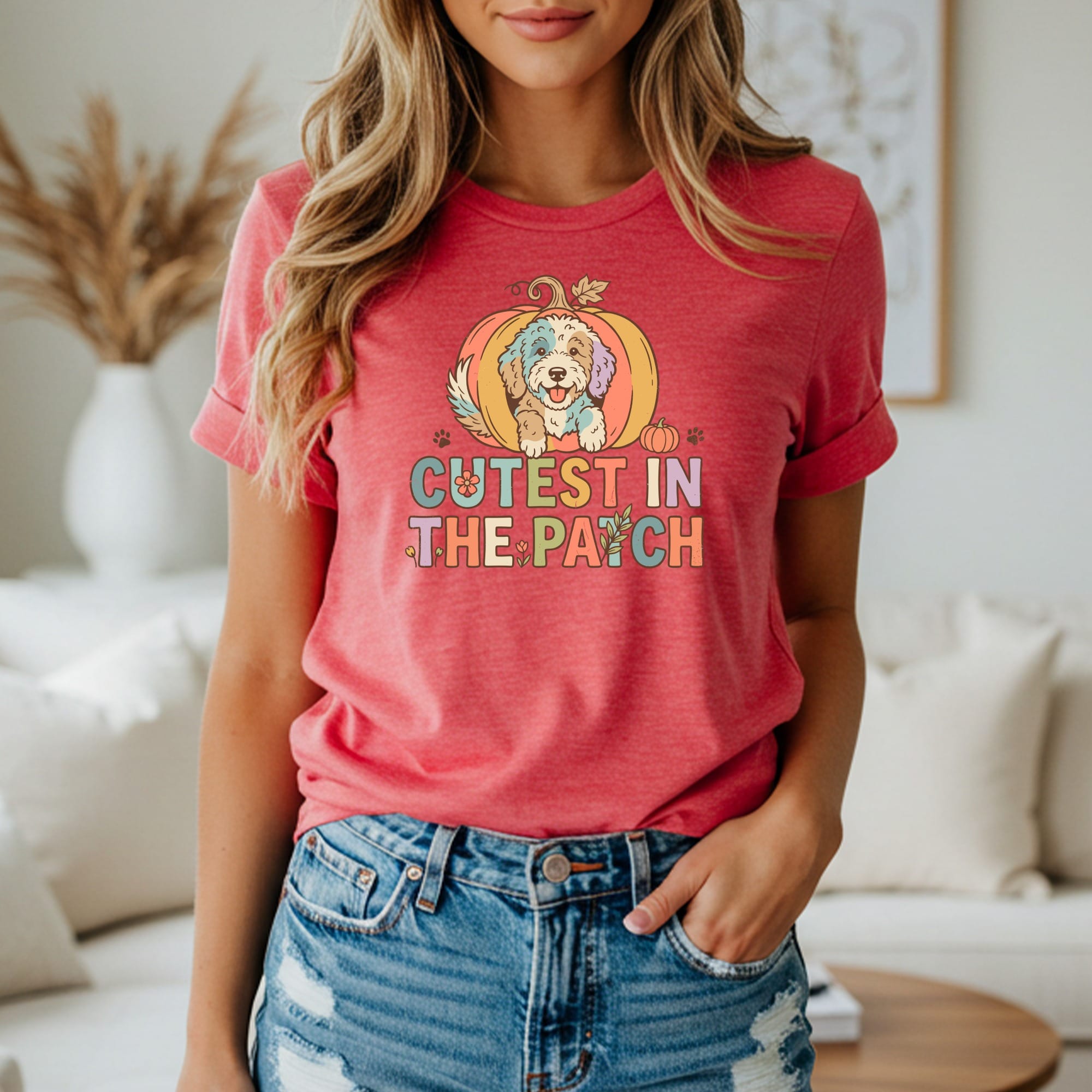 Dog in a pumpkin shirt that says "Cutest in the Patch".
