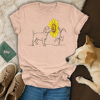 Line art t-shirt featuring a dog sniffing a sunflower, with dog and shoes nearby.