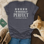 Dark grey t-shirt with white text reading "I'M BASICALLY PERFECT - according to my dog".