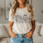 Line drawing of dogs holding ice cream cones on a cream t-shirt.