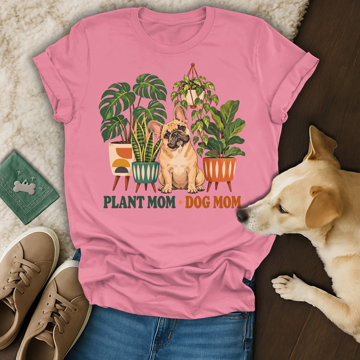 Pink t-shirt featuring a French bulldog surrounded by potted houseplants and the text Plant Mom Dog Mom.