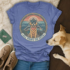 T-shirt with a golden retriever captain wearing sunglasses on a boat, with text "All Paws On Deck".