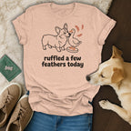 Peach t-shirt with a corgi and duck illustration and the text "ruffled a few feathers today".