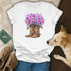 White t-shirt with floral boots graphic and dog resting on floor.