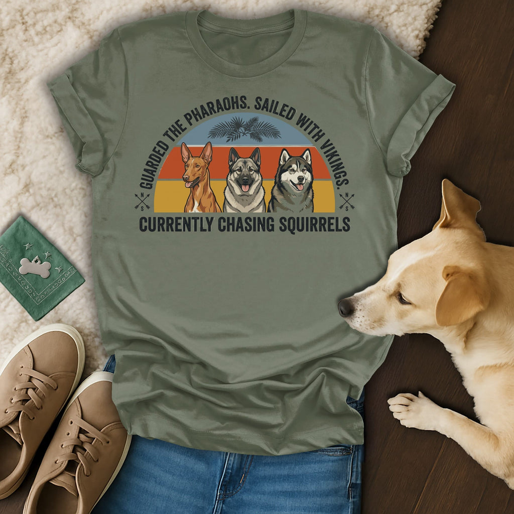 T-shirt with three dogs and text: "Guarded the pharaohs. Sailed with vikings. Currently chasing squirrels."