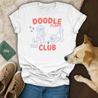 White t-shirt with "Doodle mom" and "CLUB" text and doodle dog illustrations.