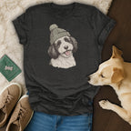 Charcoal t-shirt with dog wearing a beanie graphic and a real dog lying nearby.