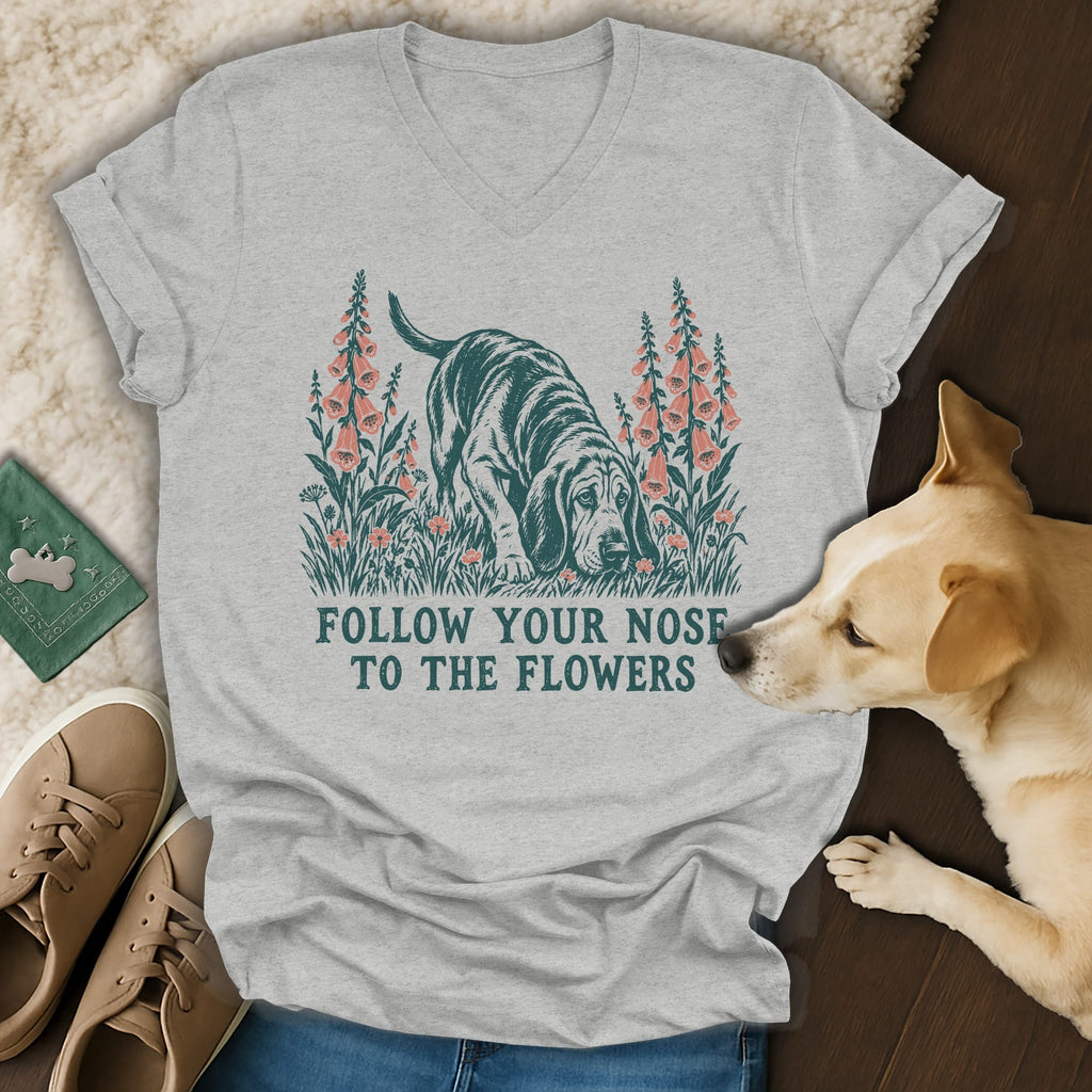 Heather gray V-neck t-shirt featuring a vintage graphic of a hound dog sniffing flowers with the text FOLLOW YOUR NOSE TO THE FLOWERS.