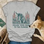 Heather gray V-neck t-shirt featuring a vintage graphic of a hound dog sniffing flowers with the text FOLLOW YOUR NOSE TO THE FLOWERS.
