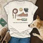 T-shirt with illustrations of a leash, dog toy, and lint roller. Text reads "I HAVE A DOG. IT'S A WHOLE PERSONALITY."